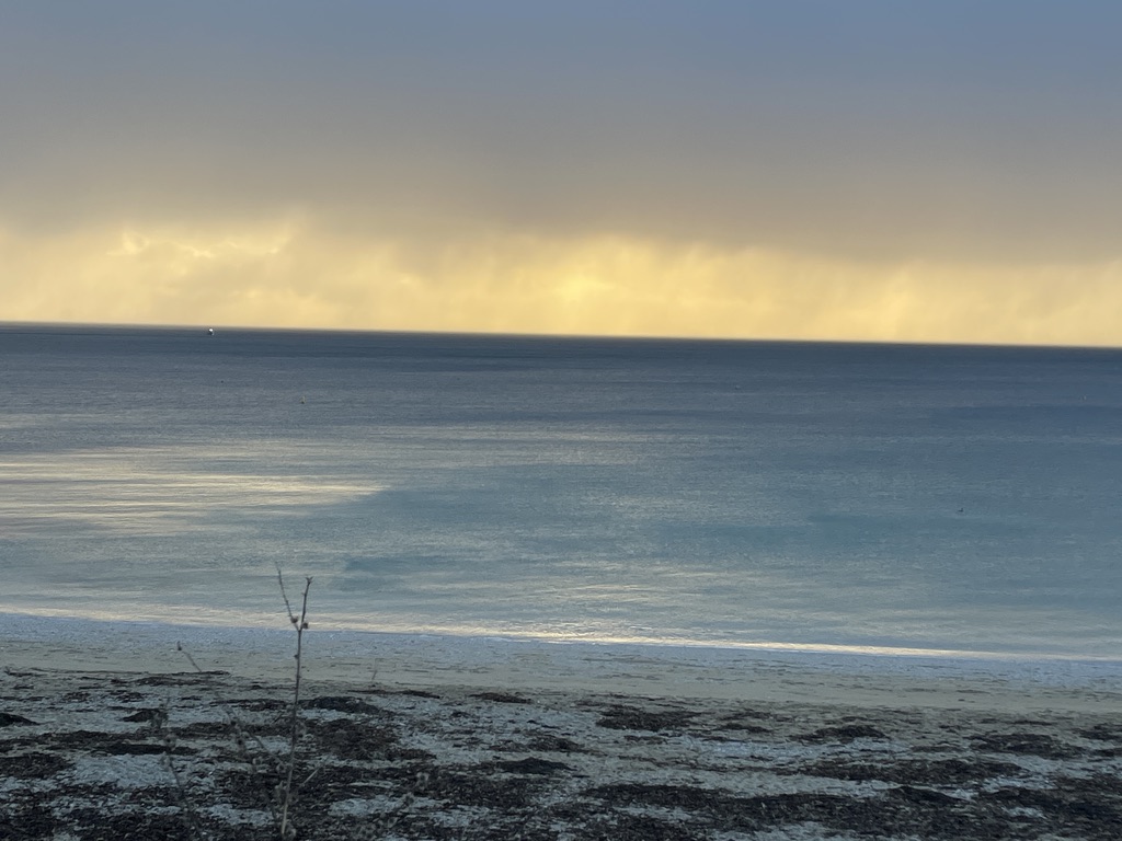 sea horizon with sleet in the distance