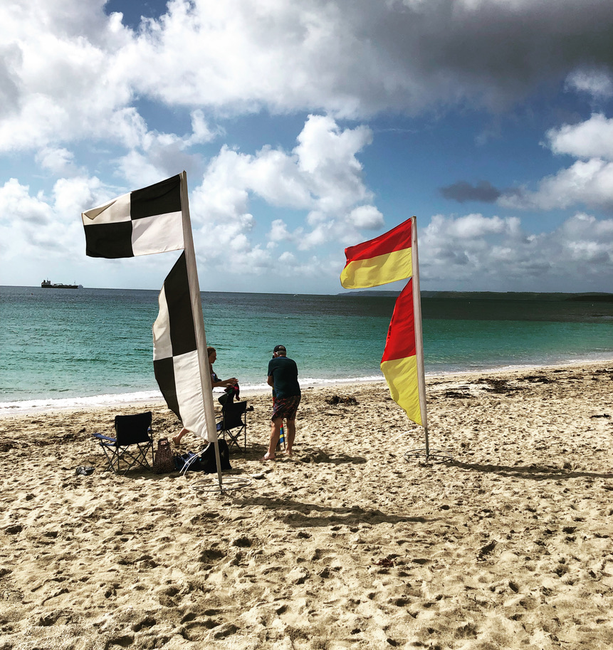 red and yellow rnli flag and black and white check flag